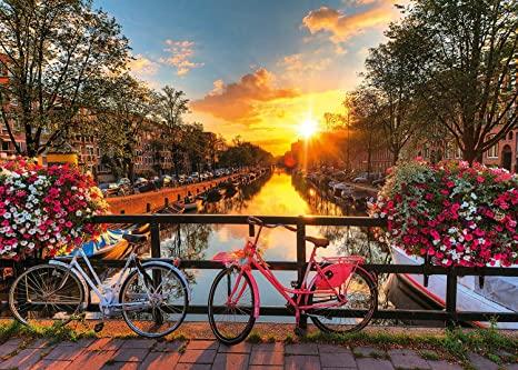 Enjoy this beautiful and romantic 1000 piece puzzle, featuring a glowing sunset over the canal in Amsterdam after a bicycle ride through the city.