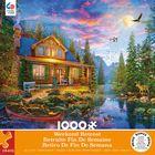 This 1000 piece Weekend Retreat puzzle features an illustration of a quaint wooden house with a stone chimney. There is a stream running beside and a canoe and wildlife in the foreground. A bonus poster is included with the puzzle.