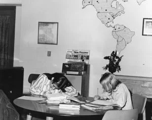 Girls studying at a table, 1972. Black and white.