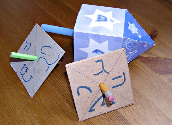 Examples of homemade paper dreidels.