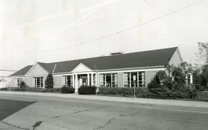 Library building exterior expanded, c1962. Black and white.