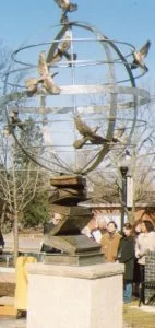 Peace sculpture dedication, March 2007. Metal sculpture is a globe with birds attached, propped on a stack of books.