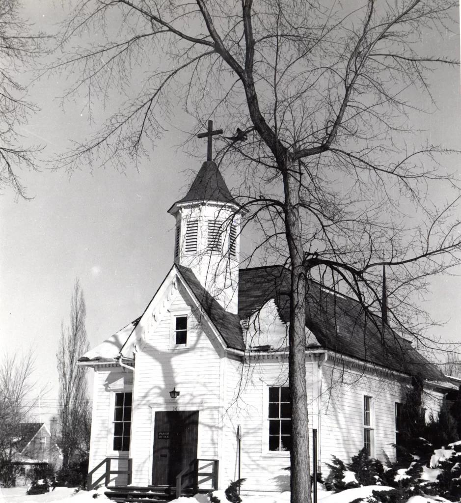 Old schoolhouse with tower in front. Black and white.