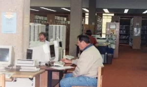 Two male patrons using internet computers, circa 1997.