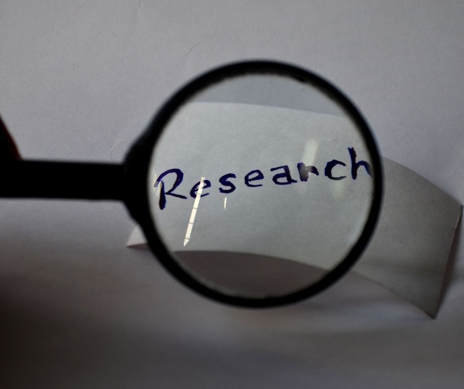 magnifying glass showing the word research