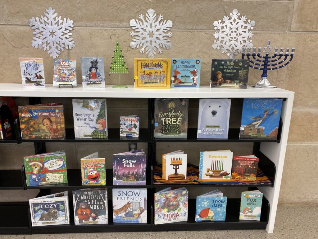 2020 winter holiday books for kids displayed on a shelf