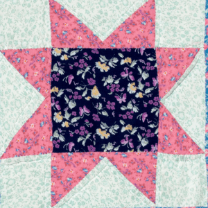 A star shape quilted together with multiple floral patterned fabrics.