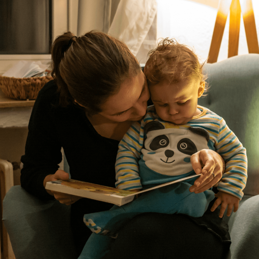 A mother reads a picture book with her baby.