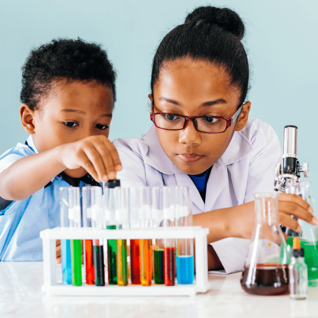 A girl and a younger boy experiment with vials of colorful liquid.