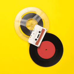 A record, cassette tape, and audio reel on a yellow background.